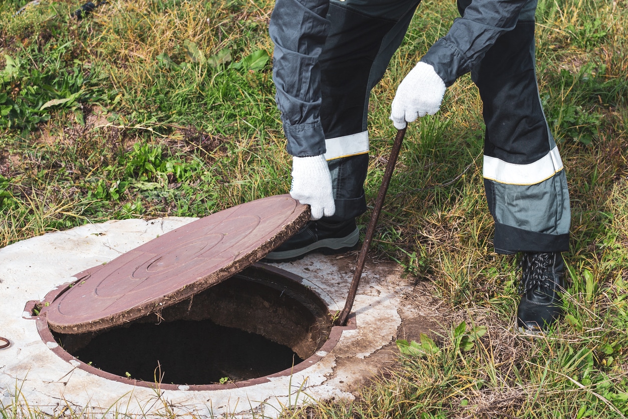Man inspecting Septic Tank